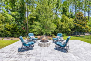 ...with built-in firepit overlooking a lush wooded landscape