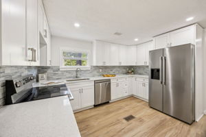 The kitchen is brand new with quartz counters and coordinating tile backsplash ...