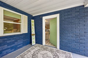 A broad covered porch welcomes you into a relaxed home designed around life by the water.