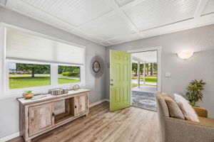 Inside, updated finishes and a detailed coffered ceiling create a bright, welcoming first impression.