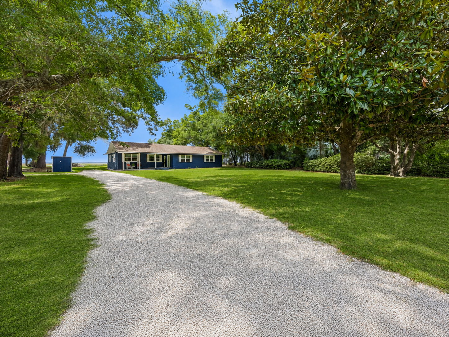 A long, tree-lined approach gives the property a private, tucked-away feel...