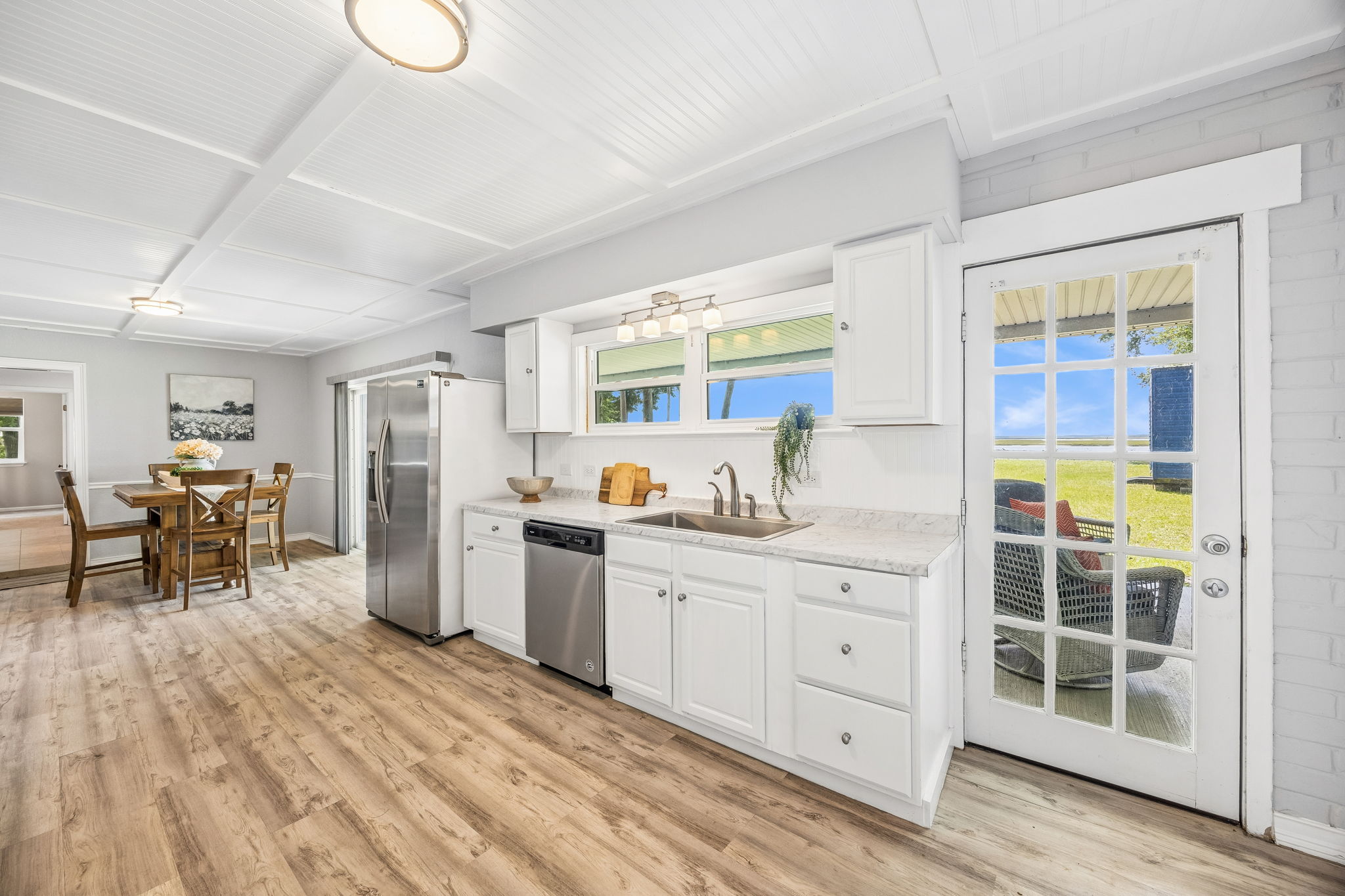 The bright kitchen keeps the river in view while offering plenty of storage and workspace...