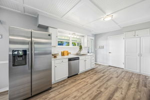 White cabinetry, stainless appliances and generous counter space keep the kitchen clean and functional...