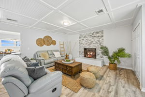 The living room adds another relaxed gathering space, complete with a fireplace for cooler evenings.