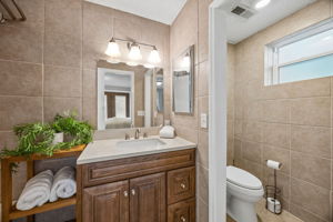 The primary ensuite bath is privately tucked away and finished in warm, neutral tones.