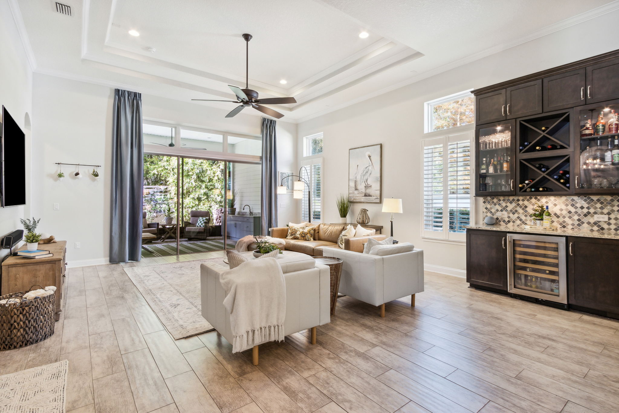 The highlight of the family room is the wall of sliding glass doors ...