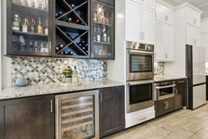 ...with additional prep space, wine cooler and glass-paneled cabinets!