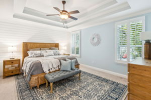 With a double tray ceiling, accent shiplap wall, and soft color palette...