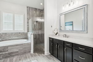 ...a soothing soaking tub and floor-to-ceiling tiled shower ...