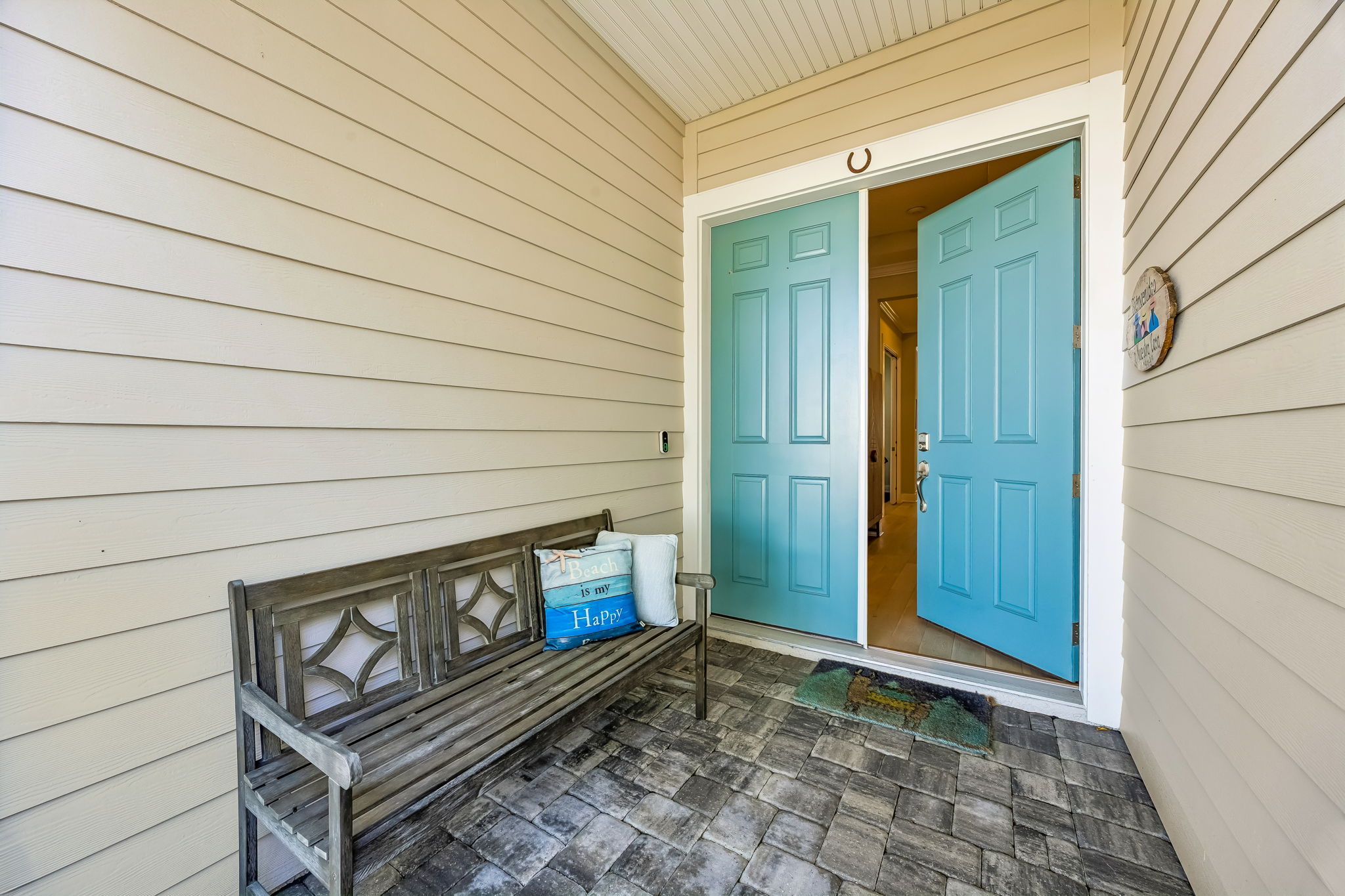 A covered front porch with double-door entry creates a warm and inviting arrival ...