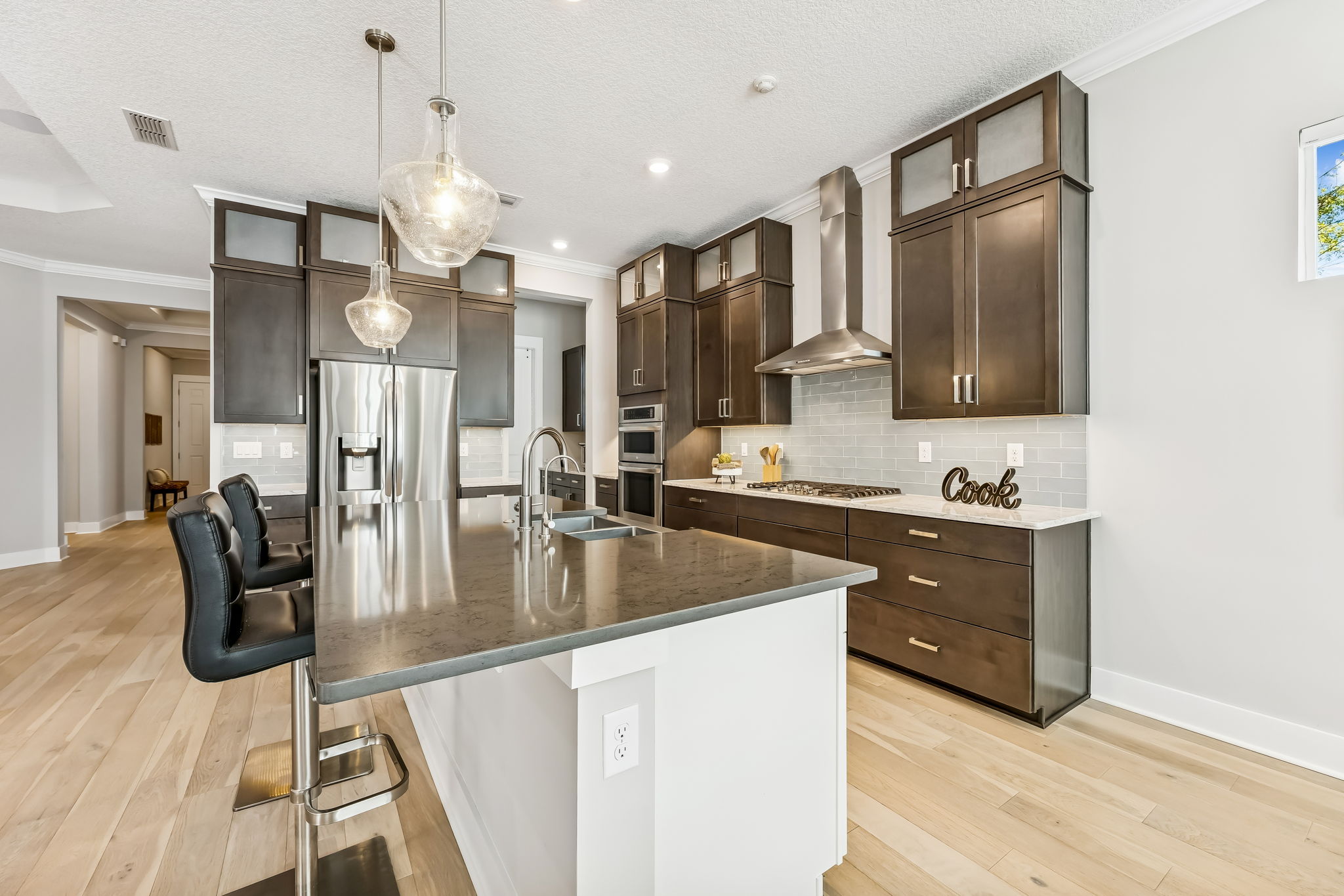 ... topped with frosted glass upper cabinets for additional storage and visual interest