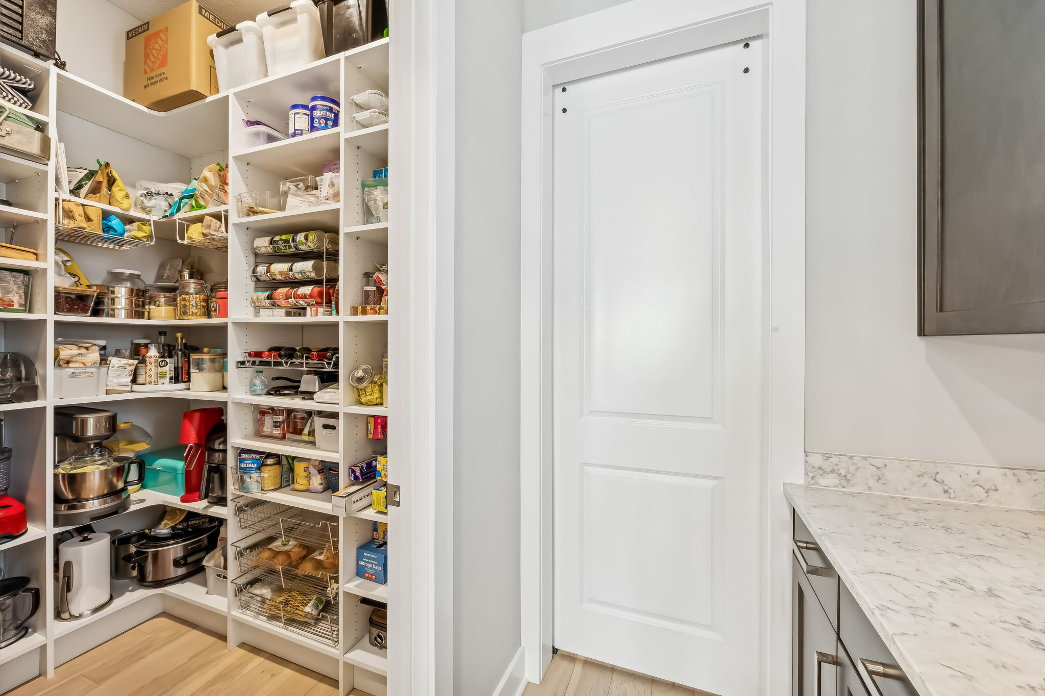 A large walk-in pantry keeps the kitchen beautifully organized and clutter-free