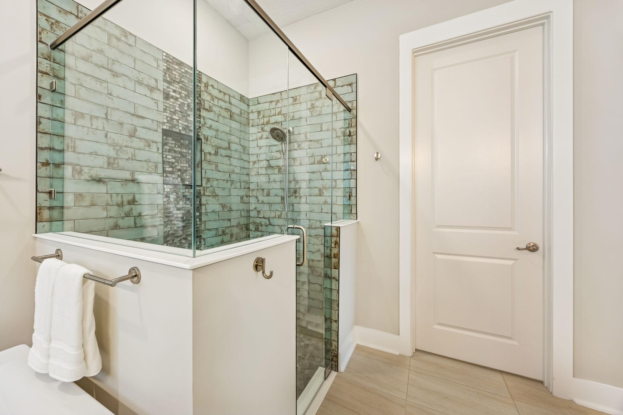 ... an oversized subway-tiled shower, and a private water closet with bidet commode