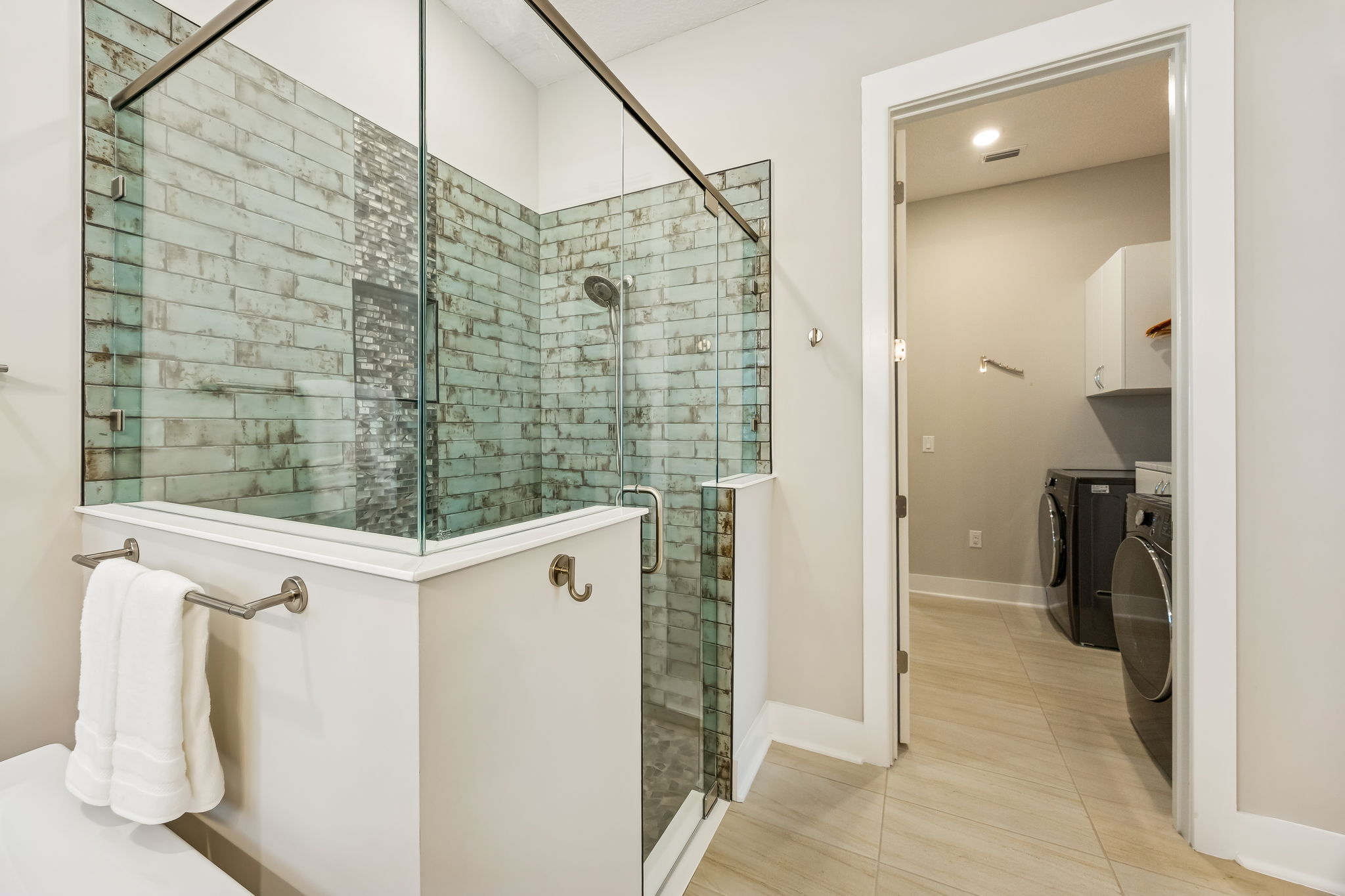 A smart, connected layout allows the primary bath to flow directly into the laundry room