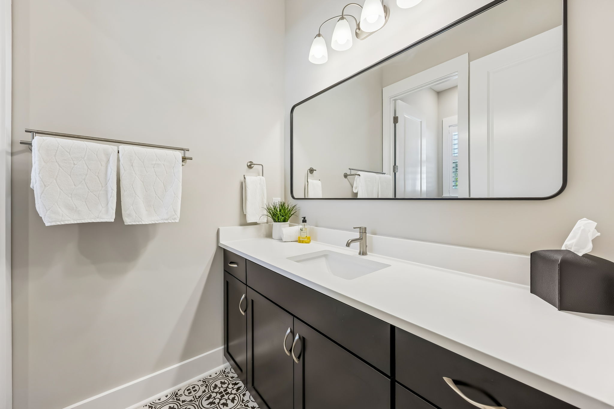 The ensuite bath is designed with a contemporary touch, with quartz countertops  ...