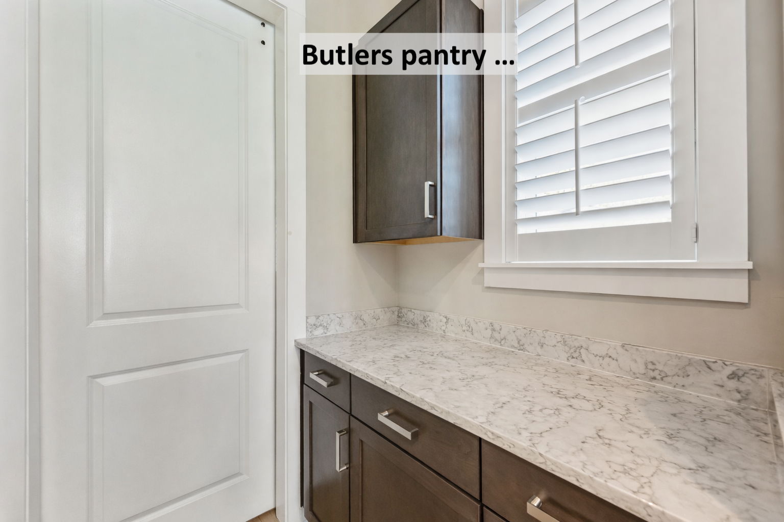 The butler’s pantry provides additional storage and functional workspace ...
