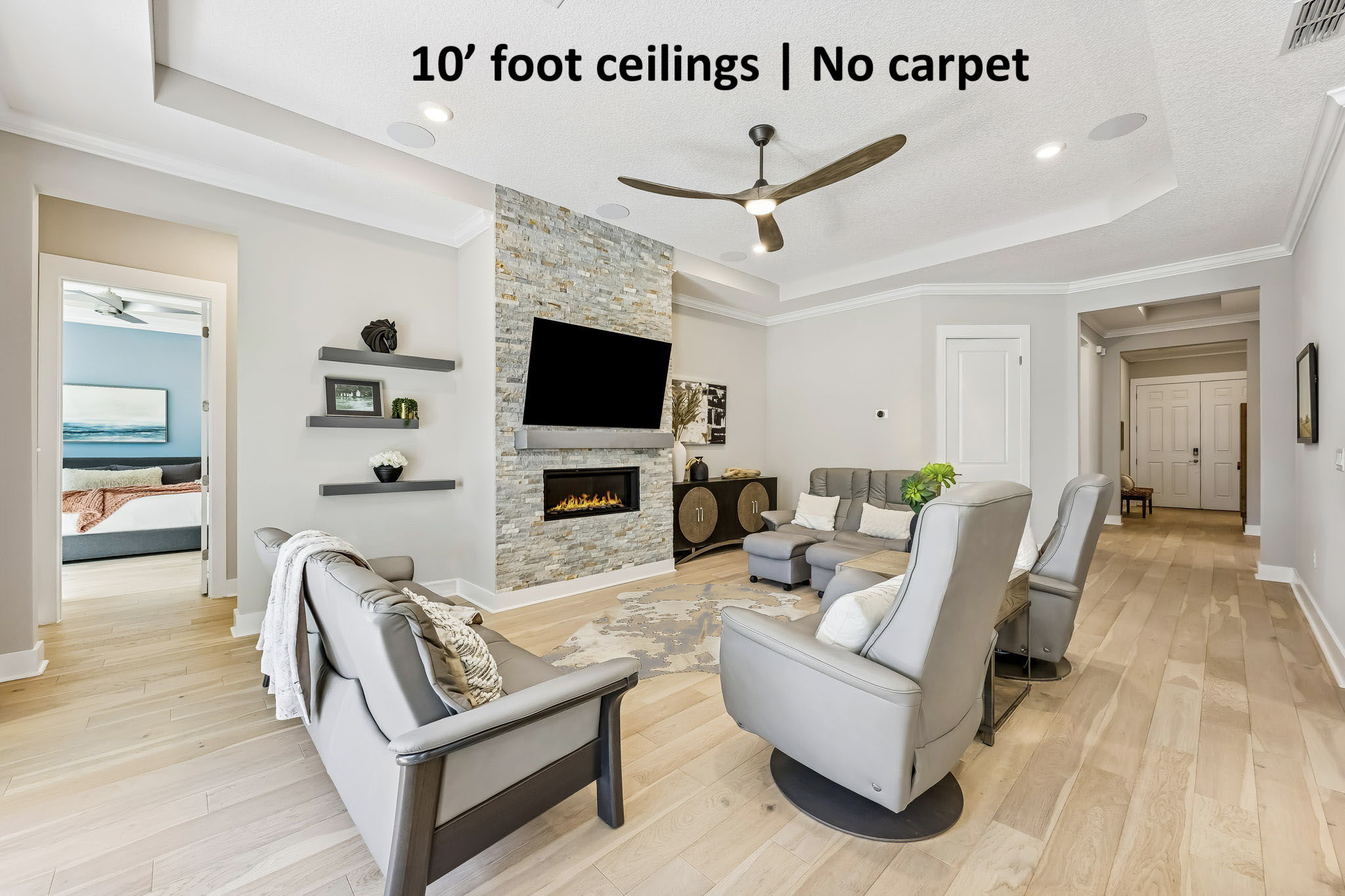 10' ceilings and no carpet anywhere, just light oak plank and tile flooring that enhances the home’s airy feel