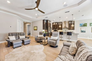 The spacious living room offers flexible seating options with room for multiple sofas or chairs ...