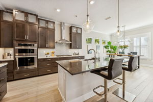 The kitchen is impressively designed with 42" shaker cabinetry in a rich espresso finish ...