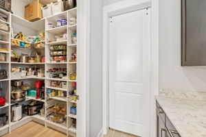 A large walk-in pantry keeps the kitchen beautifully organized and clutter-free