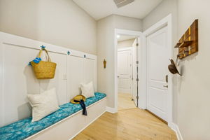 A convenient drop zone off the garage features bench storage and a place to neatly stow bags, shoes, and gear