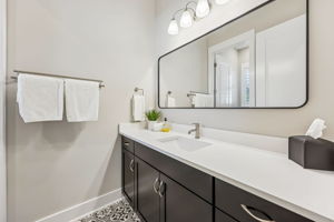 The ensuite bath is designed with a contemporary touch, with quartz countertops  ...