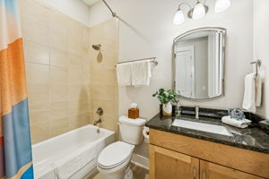 The second bedroom’s ensuite bath features a tiled shower/tub combination