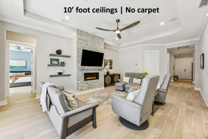 10' ceilings and no carpet anywhere, just light oak plank and tile flooring that enhances the home’s airy feel
