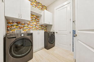 With whimsical butterfly wallpaper and a practical utility sink ...