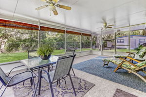 The spacious screened-in porch overlooks the expansive back yard