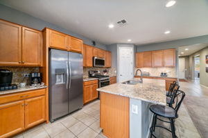 Maple cabinets, quartz counters and stainless appliances