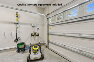 ... and lawncare equipment, including a Ryobi mower, weed wacker,  and fertilizer spreader.