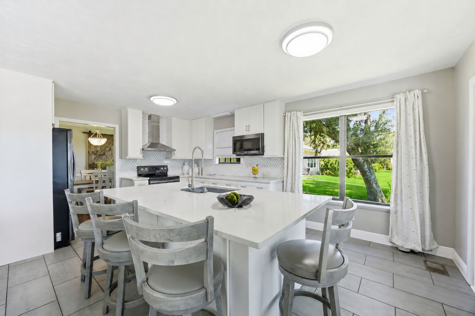 A spacious island offers abundant prep space and comfortable seating for casual meals and conversation