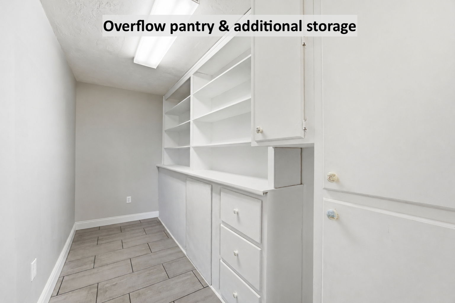 Just beyond, an overflow pantry adds built-in storage and practical space to keep the kitchen beautifully organized