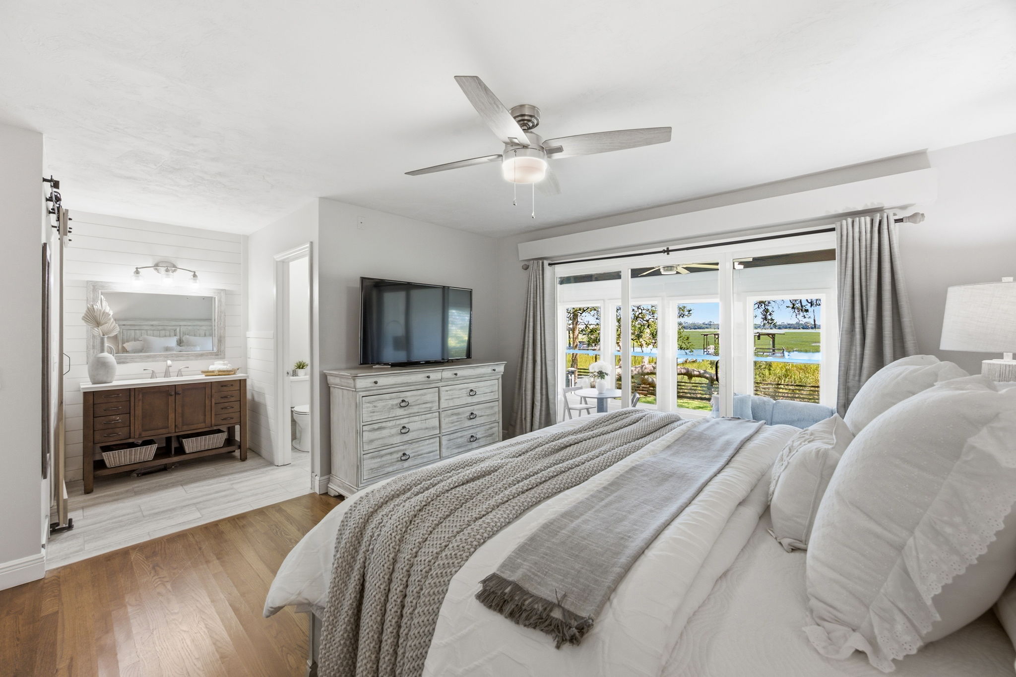 … where wide glass doors bring the marsh and waterfront into view from the moment you wake