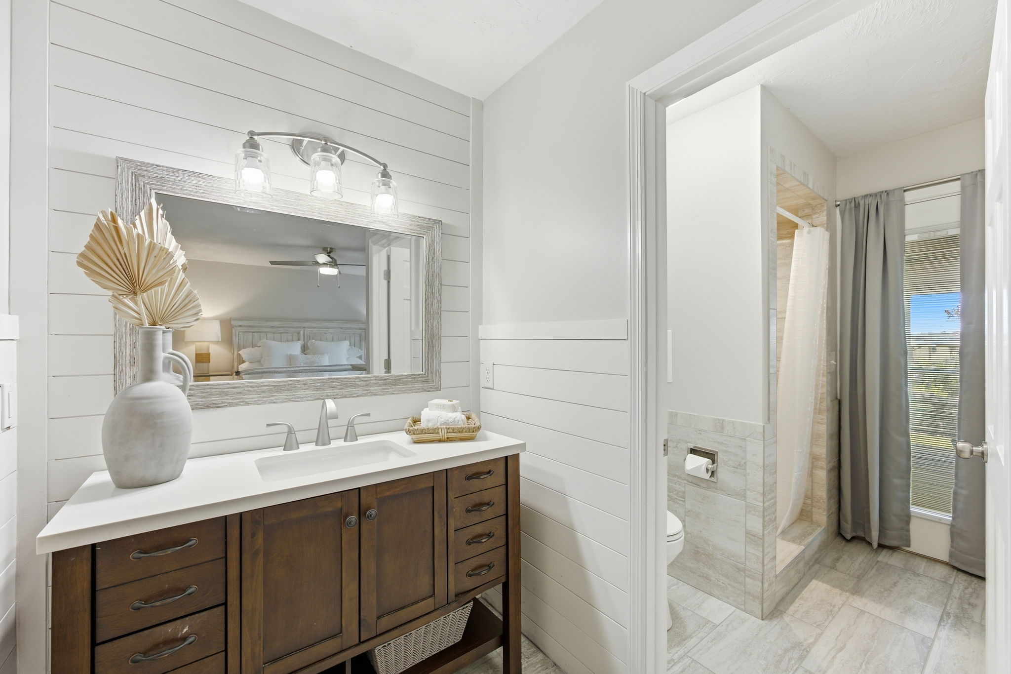 … creating a calm transition from the bedroom to the separate bathing area just beyond