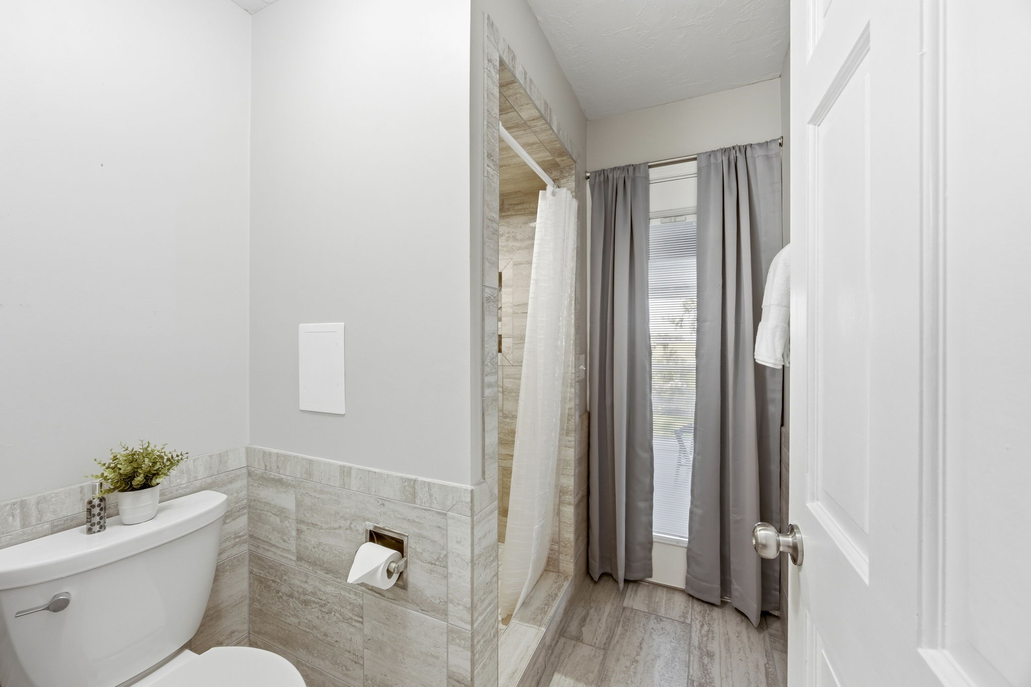 The bath continues with coordinated tile, clean finishes and a layout designed for everyday ease