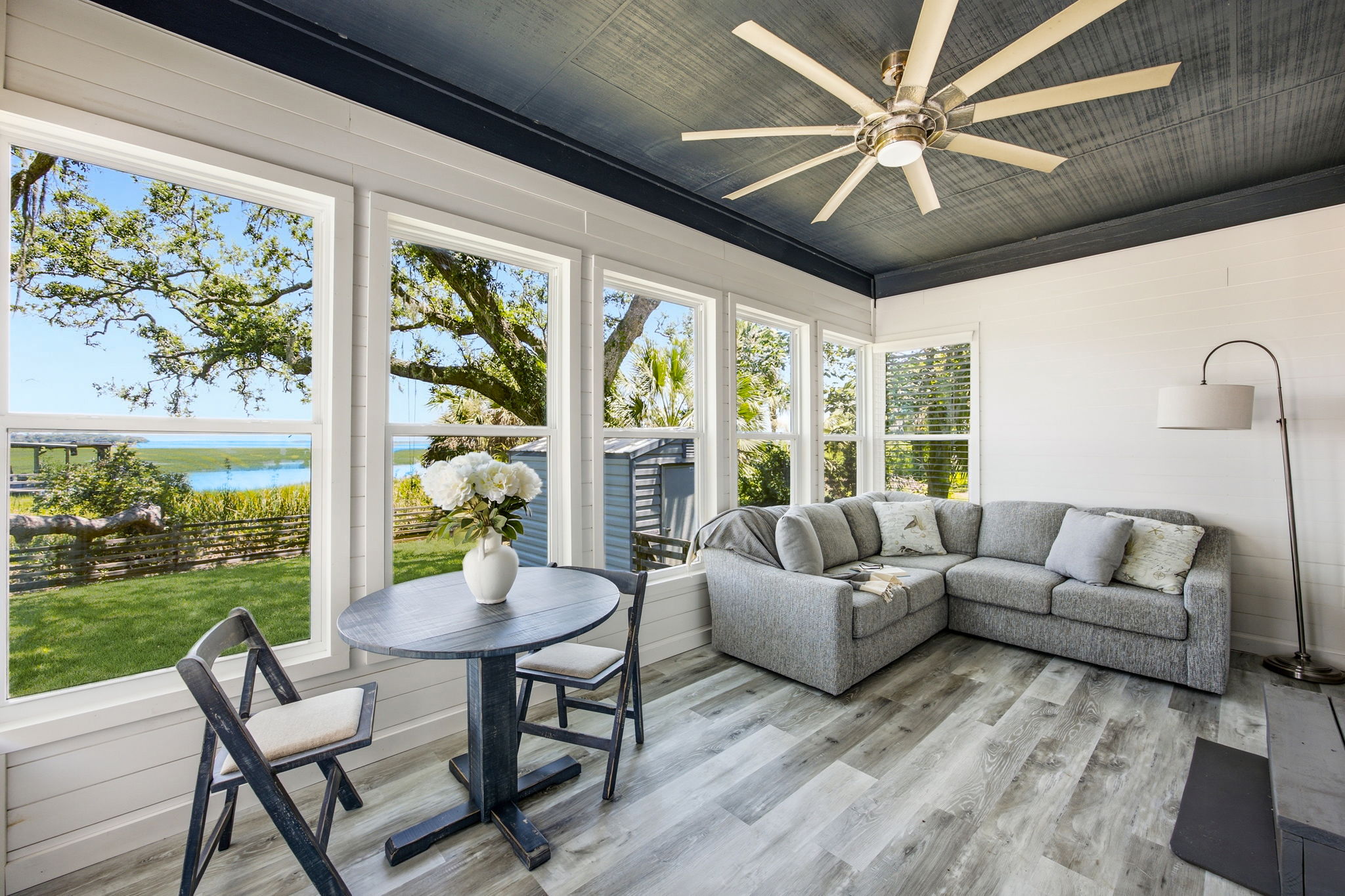 … with walls of windows framing the marsh, mature oaks and the changing light throughout the day