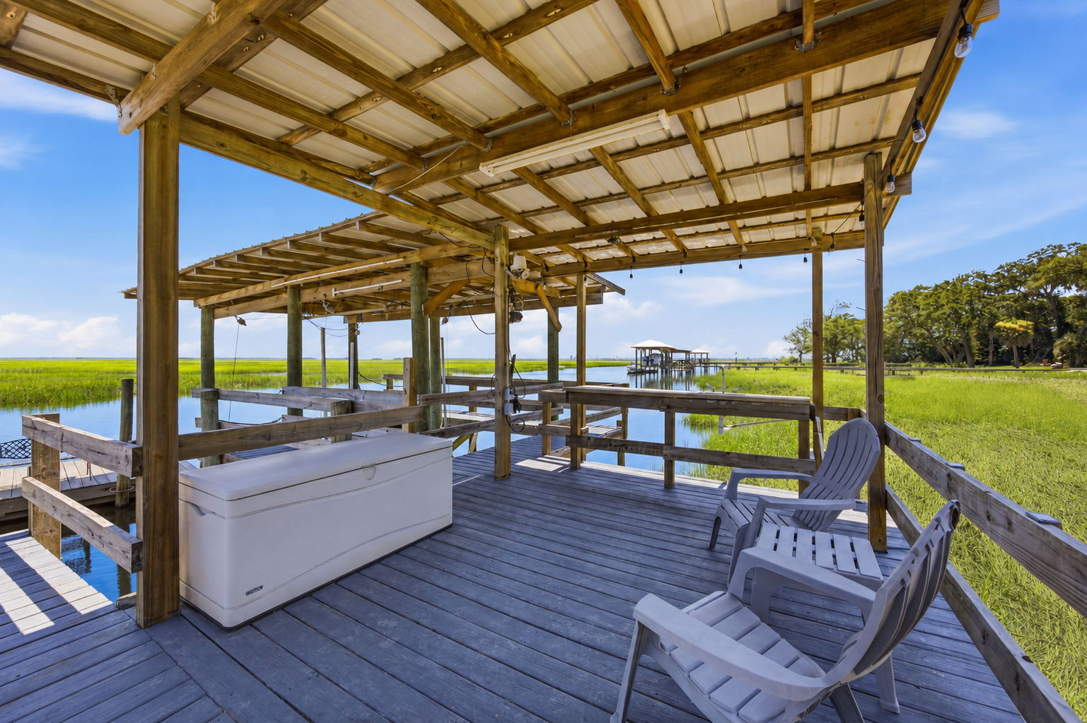 The covered dock offers space to gather, unwind and enjoy the water in comfort throughout the day