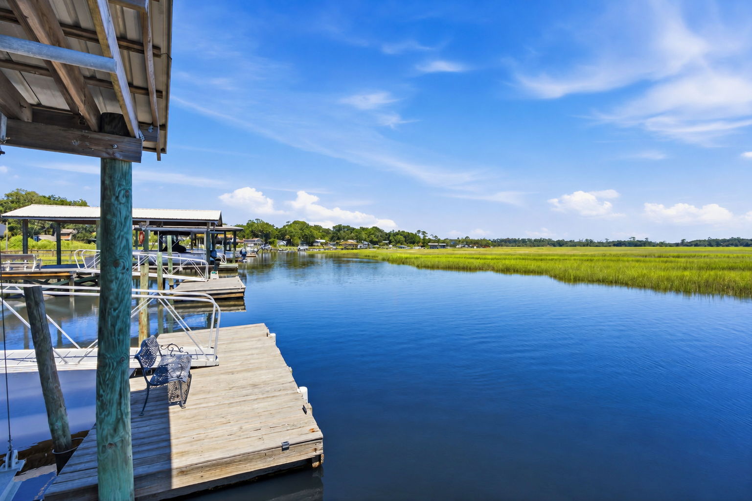 From the dock, broad water and open marsh create a peaceful setting for fishing, boating or simply slowing down
