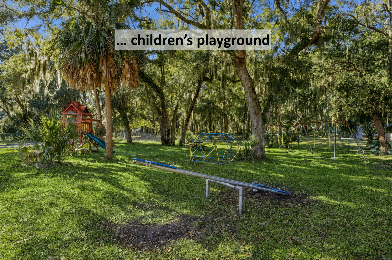 Nearby, a shaded playground gives children room to play beneath the community’s moss-draped canopy