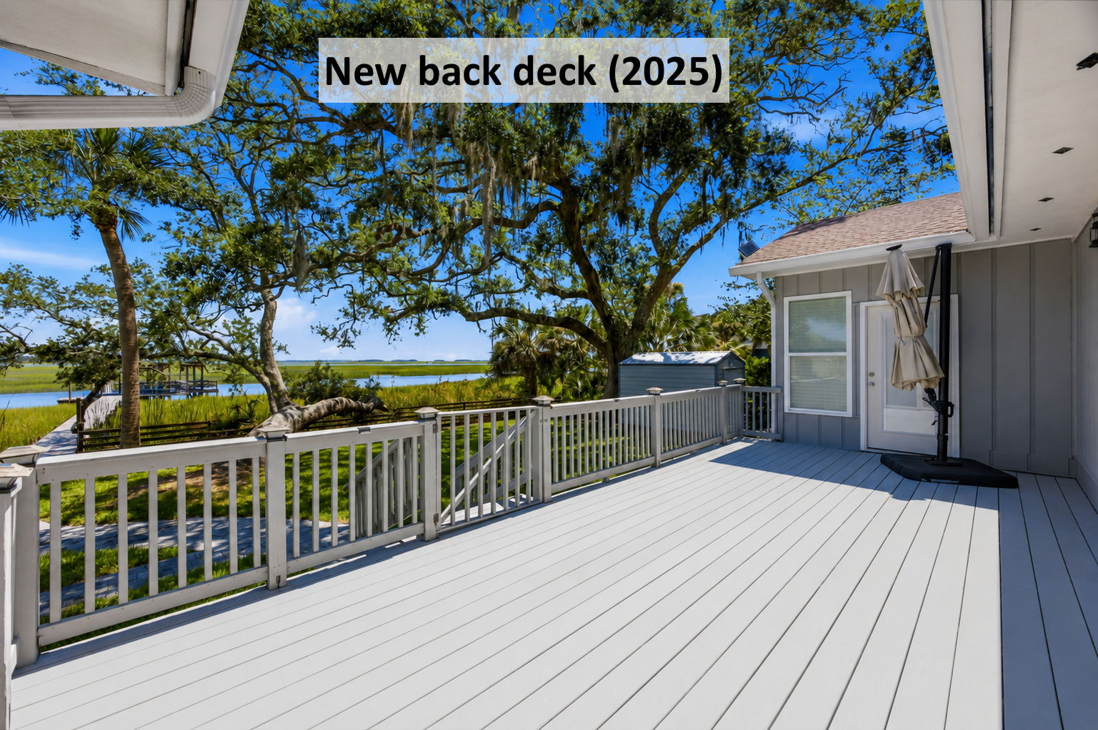 The new back deck extends daily living toward the marsh, with room to relax, dine and take in the view