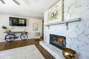 A painted stone fireplace anchors the room, adding texture, character and an inviting place to gather