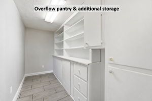 Just beyond, an overflow pantry adds built-in storage and practical space to keep the kitchen beautifully organized
