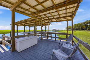 The covered dock offers space to gather, unwind and enjoy the water in comfort throughout the day