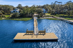 A floating platform extends the pier into open water, offering space to pause and take in the setting