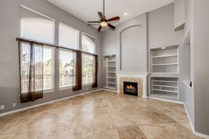 Family room with high ceilings and a cozy fireplace