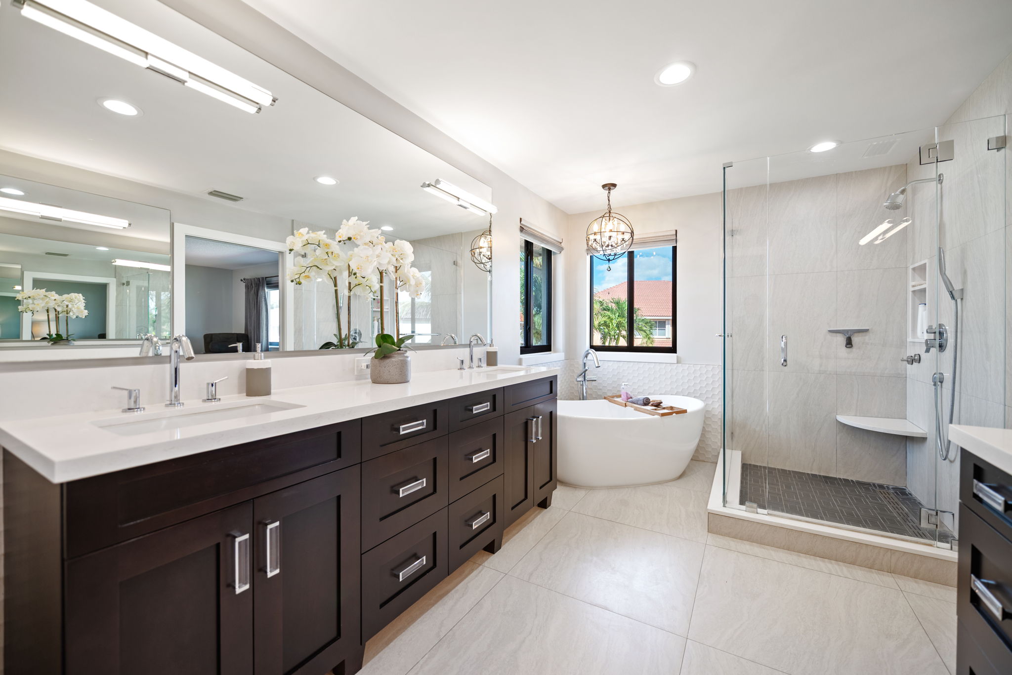 Owner's suite bathroom features a supersized dual sink vanity, freestanding tub and frameless glass shower