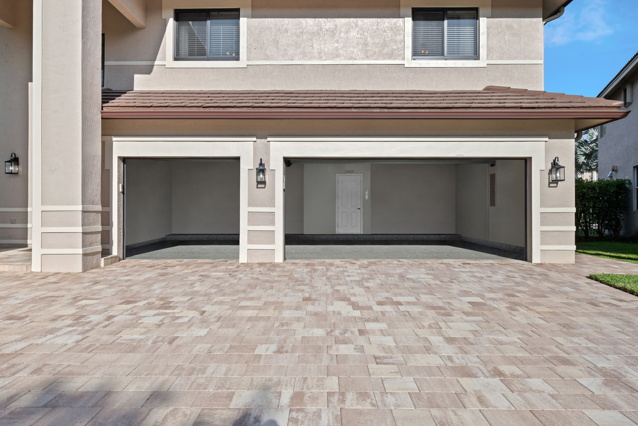 3-Car Garage features 2 heavy duty ceiling mounted storage racks