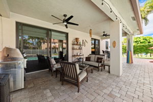 Your 300 sq ft roofed, shady back patio with plenty of room for the BBQ, outdoor sofa/chairs, a 4-chair hightop and a hammock